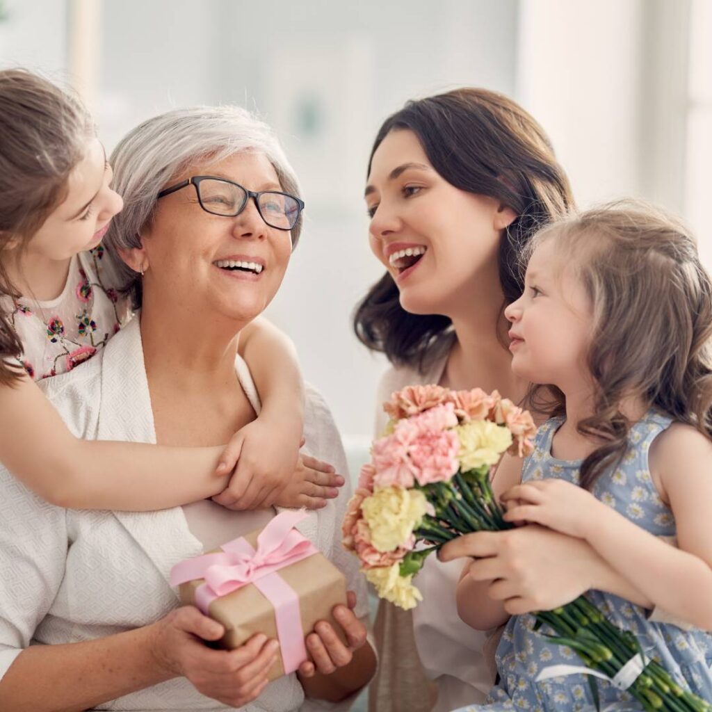 3 Generations of women celebrating and laughing together on Mother's Day