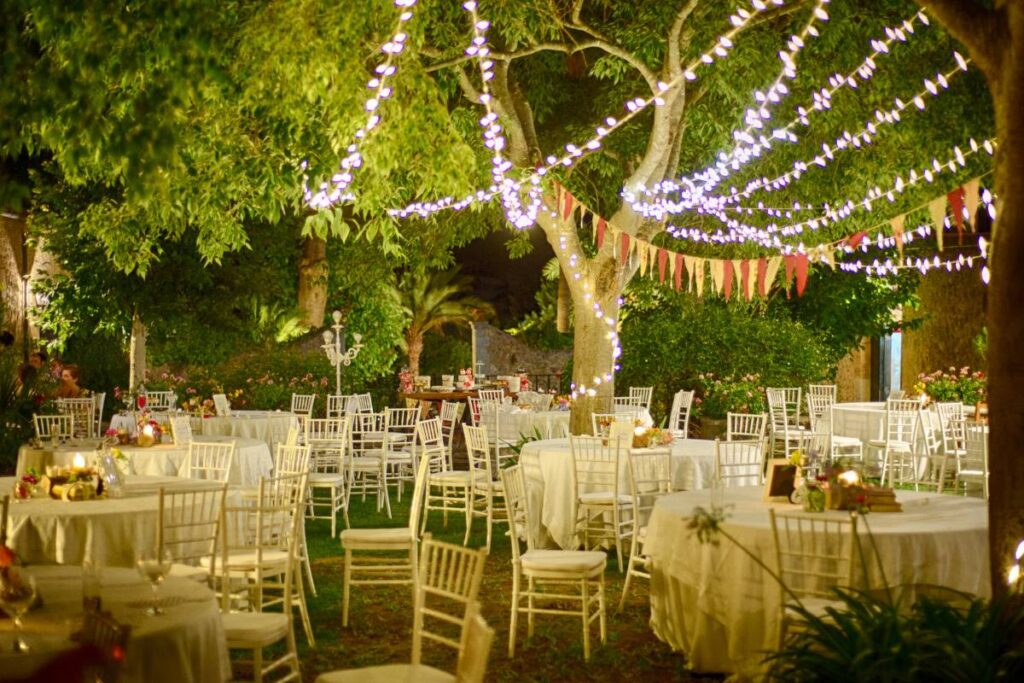 fairy lights strung over the tables in order to create festive ambiance while hosting an outdoor event