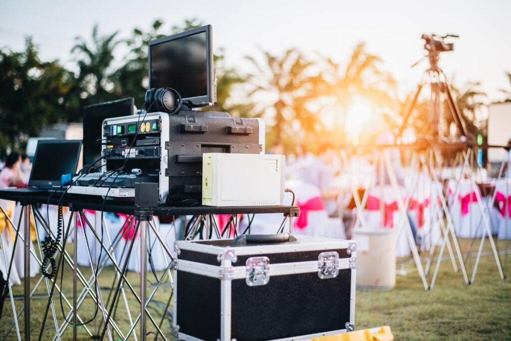 a sound system set up among the tables and chairs to host a fun outdoor event